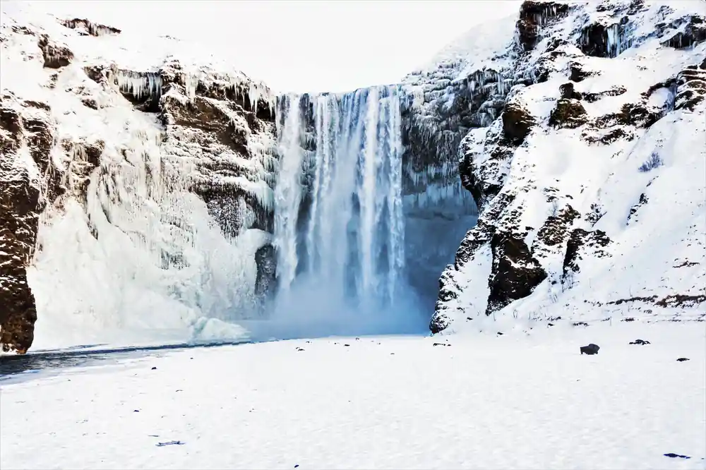 Frozen waterfall in snowy canyon landscape