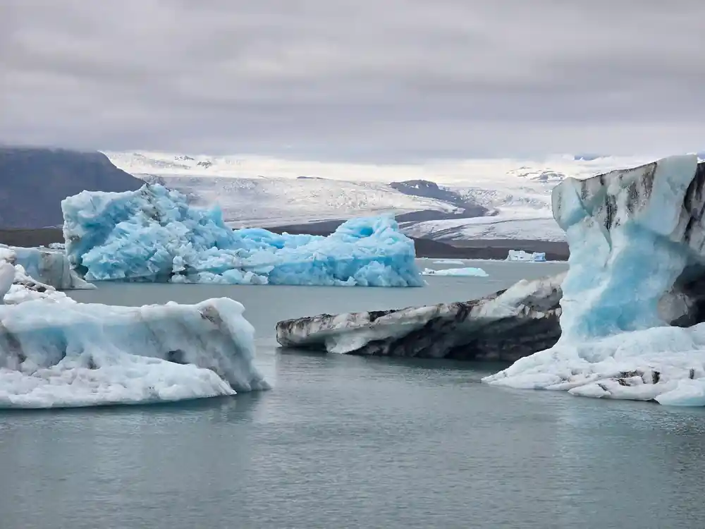 Multiple large icebergs in glacial lagoon water