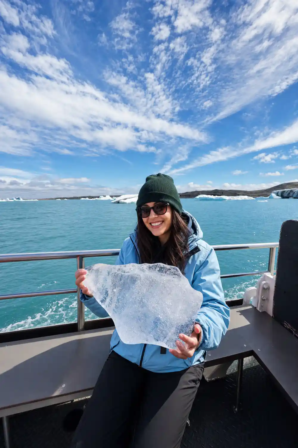 Person holding large pink fish on boat