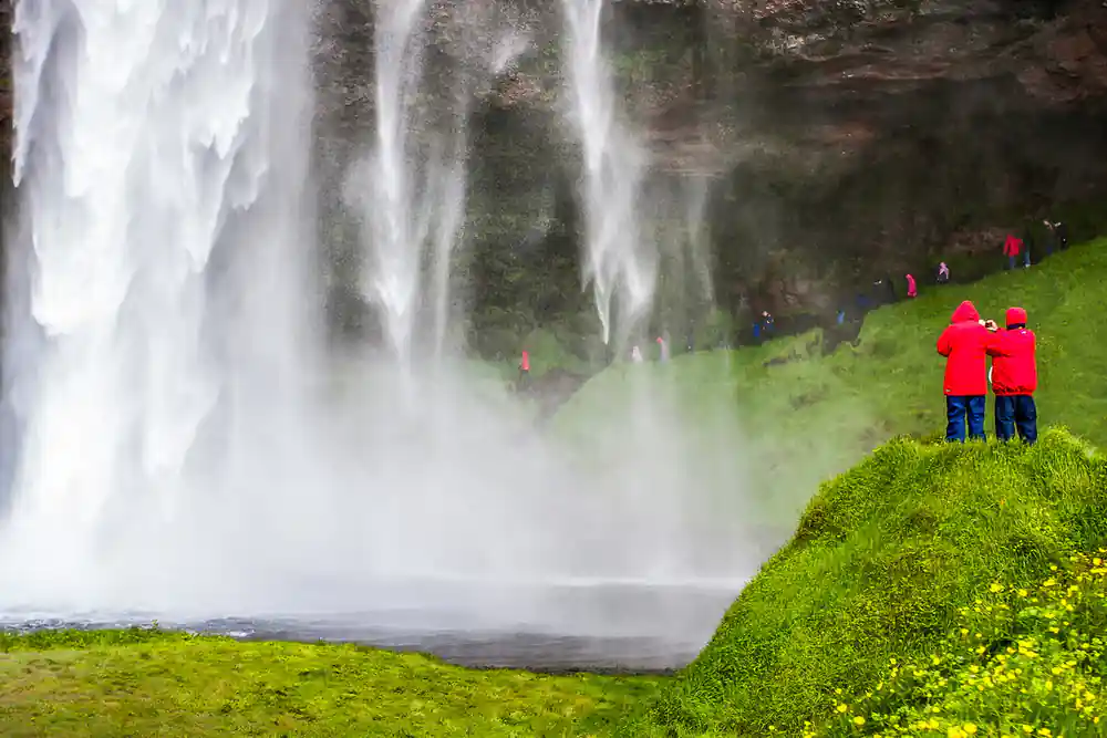 Waterfall cascading onto green moss-covered ground